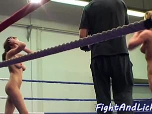 The lezzie says, 'Wrestle me, babe!' groping her fake tits during the fight