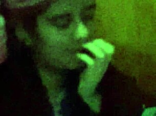 The 18-year-old girl with wet pink hair participates in a wet scene.