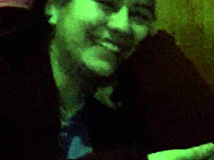 The 18-year-old girl with wet pink hair participates in a wet scene.