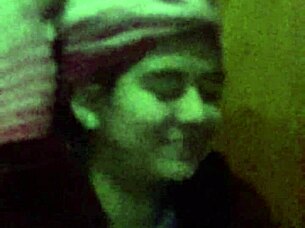 The 18-year-old girl with wet pink hair participates in a wet scene.