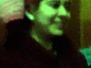 The 18-year-old girl with wet pink hair participates in a wet scene.