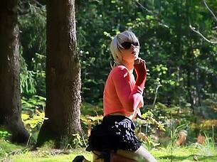 Shemale slut plays with toys in forest.