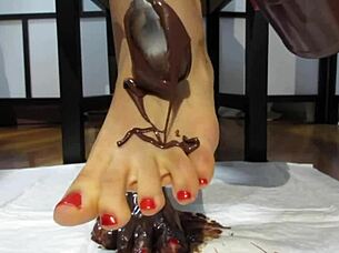 Feet with varnished nails covered in chocolate cream.