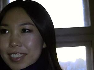 Young Asian girl performing oral in public setting