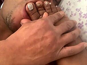 wife sucks toes while giving handjob