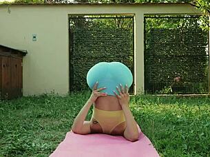 sexy yoga stretches in blue leggings on green meadow with big natural tits bouncing 😍