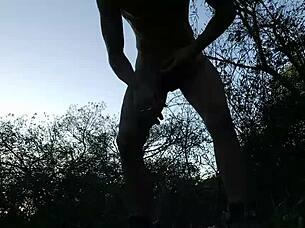 A latino guy masturbates his big cock in the forest before getting caught