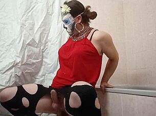 A travesti plays with a gode in her bedroom