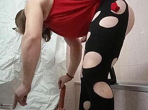 A travesti plays with a gode in her bedroom