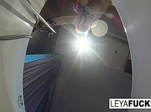 Leya Falcon enjoys a shower, using the tub head on her ass.