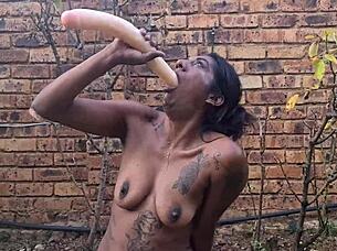 indian babe deepthroats dildo and gags in garden