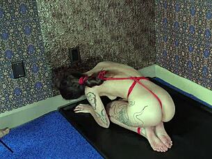 This bondage slut gets choked while licking her dom master's ass