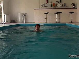 redhead masturbates outdoors in bikini at pool