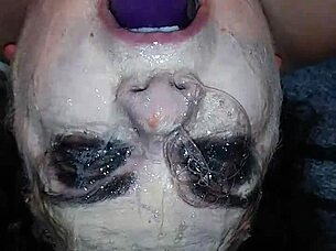 Ms TL takes dildo deep in throat.