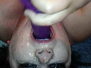 Ms TL takes dildo deep in throat.