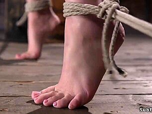 Goth babe endures tight hogtie suspension in rough play