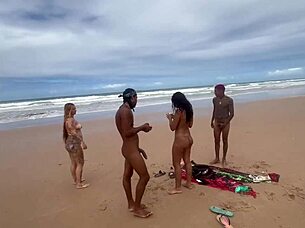 Passionate beach encounter with everyone watching