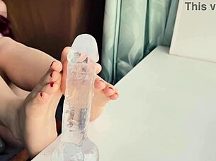 redhead gives footjob with red nails