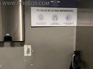 In a bustling restaurant, a girl performs a blowjob on her partner discreetly.