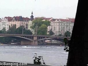 A busty teen encounters a group of guys in a public street setting for an outdoor activity