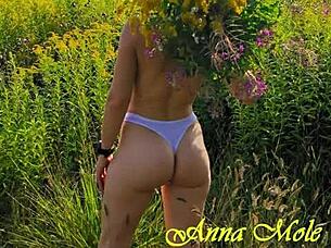 A girl with gorgeous small breasts walks in nature wearing short shorts and a t-shirt named anna mole