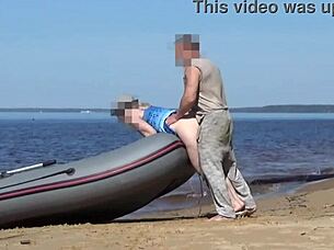 lady tourist interacts with boatman on beach