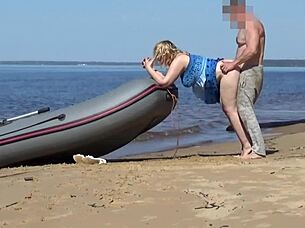 lady tourist interacts with boatman on beach