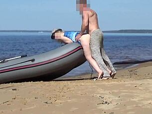 lady tourist interacts with boatman on beach