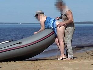 lady tourist interacts with boatman on beach