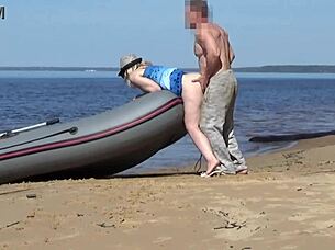 lady tourist interacts with boatman on beach