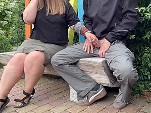 A mature woman risks being seen in the public park.