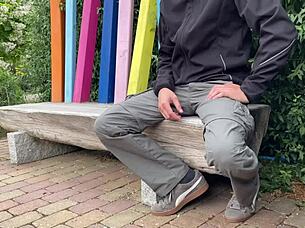 A mature woman risks being seen in the public park.