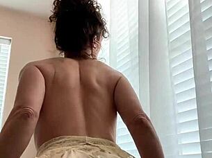 Indian babe performs striptease with puffy tits flashing.