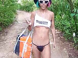 Walking topless in forest, hairy latina babe exposes small waist and pussy.