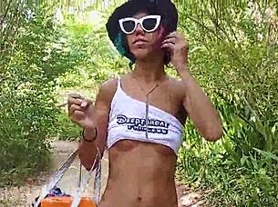 Walking topless in forest, hairy latina babe exposes small waist and pussy.