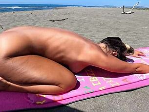 Beach bombshell Sexydea strips for erotic nude beach display.