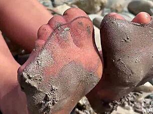 Goddess shows her messy nylon feet close up. Torn pantyhose on the river bank 😍