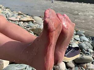 Goddess shows her messy nylon feet close up. Torn pantyhose on the river bank 😍
