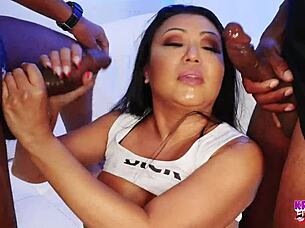 Horny asian milf gets covered in cum during a 5 bbc blowbang session.