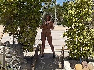 Beautiful exhibitionist flashes in microbikini outdoors