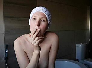 A beautiful and cute brunette girl smokes a cigarette