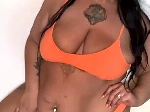 Ebony pornstar with big tits and ass dances in bikini, getting horny