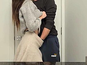 A petite girl in a miniskirt bends over in the public bathroom, moaning as she reaches orgasm.