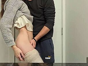 A petite girl in a miniskirt bends over in the public bathroom, moaning as she reaches orgasm.