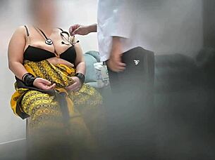 doctor examines indian patient in asian clinic setting