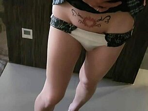 This ladyboy teases and flirts shamelessly in front of the mirror. Every angle is pure seduction.