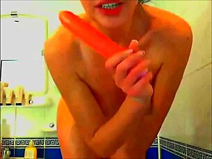 tattooed model masturbates with glass dildo in bathroom