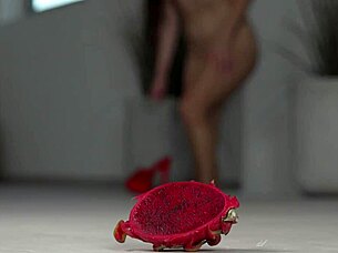 brunette crushes fruits with bare feet and heels in footfetish video