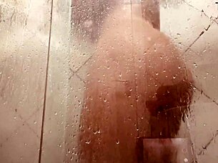 Milf films herself washing hairy pussy in steamy bathroom