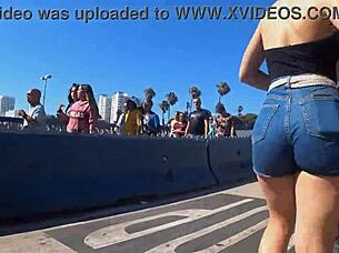 In a public outdoor setting, a voyeur captures a candid shot of a big ass in tight shorts and jeans.